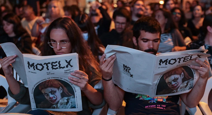 pessoas com jornal motelx